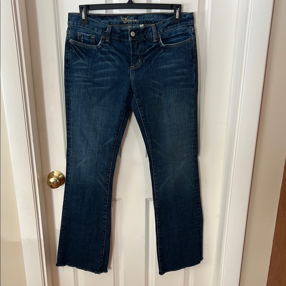 bebe, woman’s, blue, jeans. Size 31. Rhinestone design on back pockets.